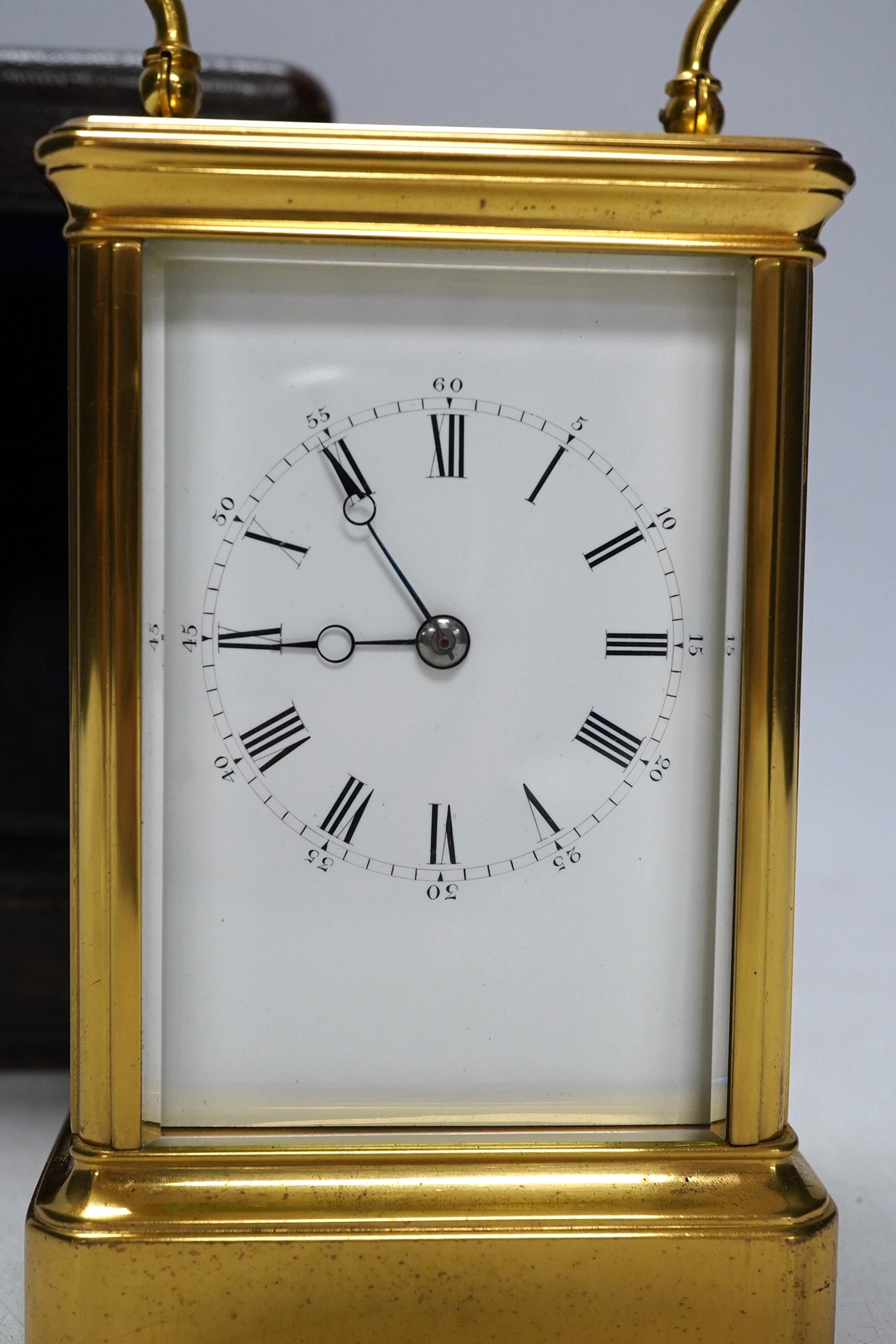 A cased unnamed brass carriage clock, 14cm tall. Condition - fair